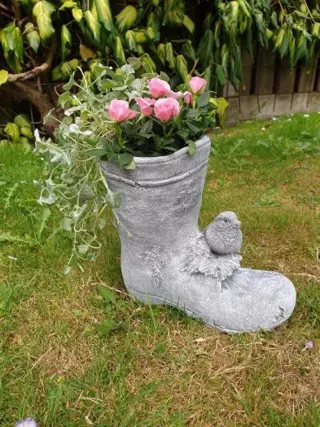 Bloempot als oude laars , bloembak met vogel