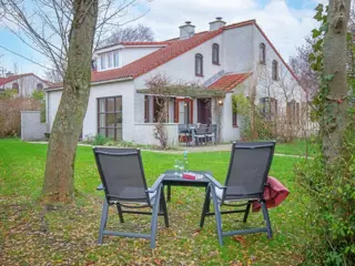 Vakantiehuis met een grote tuin en rondom flinke struiken en bomen