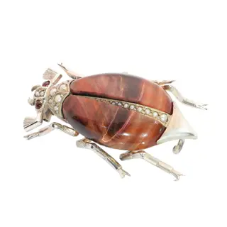 A circa 1880 beetle brooch with reddish tigers eye and seed pearls