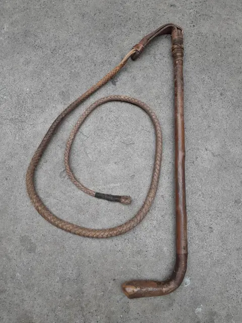 Antique leather hunting whip with wooden handle