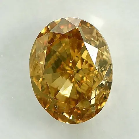 Diamant - 0.58 ct - Ovaal - Natural Fancy Orangy Yellow -