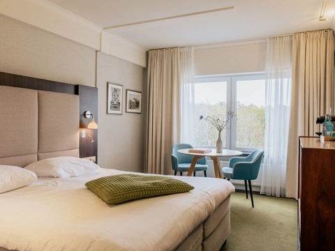 Kamer met uitzicht over de duinen in luxe hotel