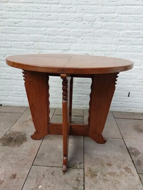Een ronde houten tafel met los glazen blad