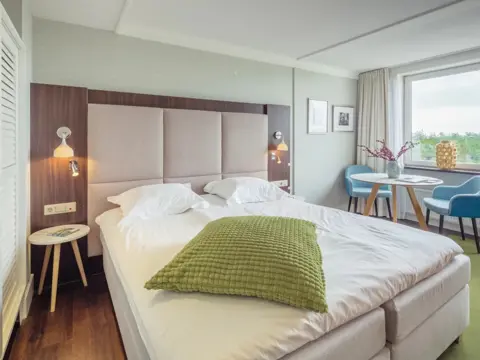 Kamer met uitzicht over de duinen in luxe hotel